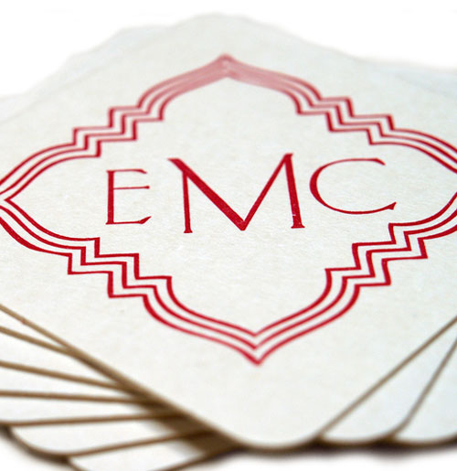 Custom coasters printed in cherry red.